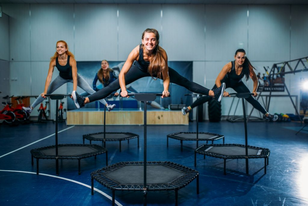 Women group on sport trampoline, fitness workout